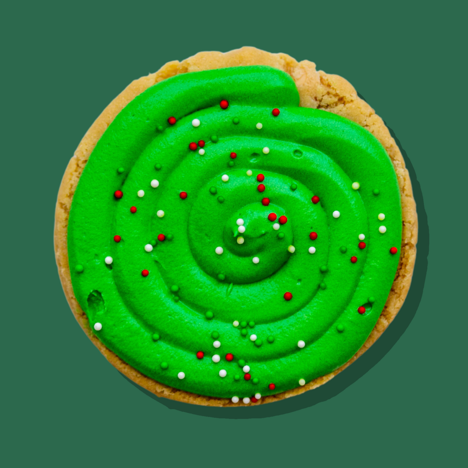 Under the Mistletoe Maxi cookie with green toffee apple cream cheese frosting and festive sprinkles.