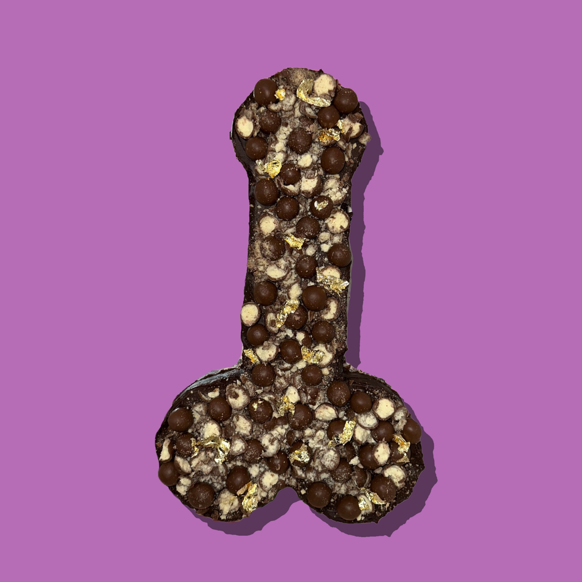 NSFW brownie in explicit shape with customizable toppings on purple background.