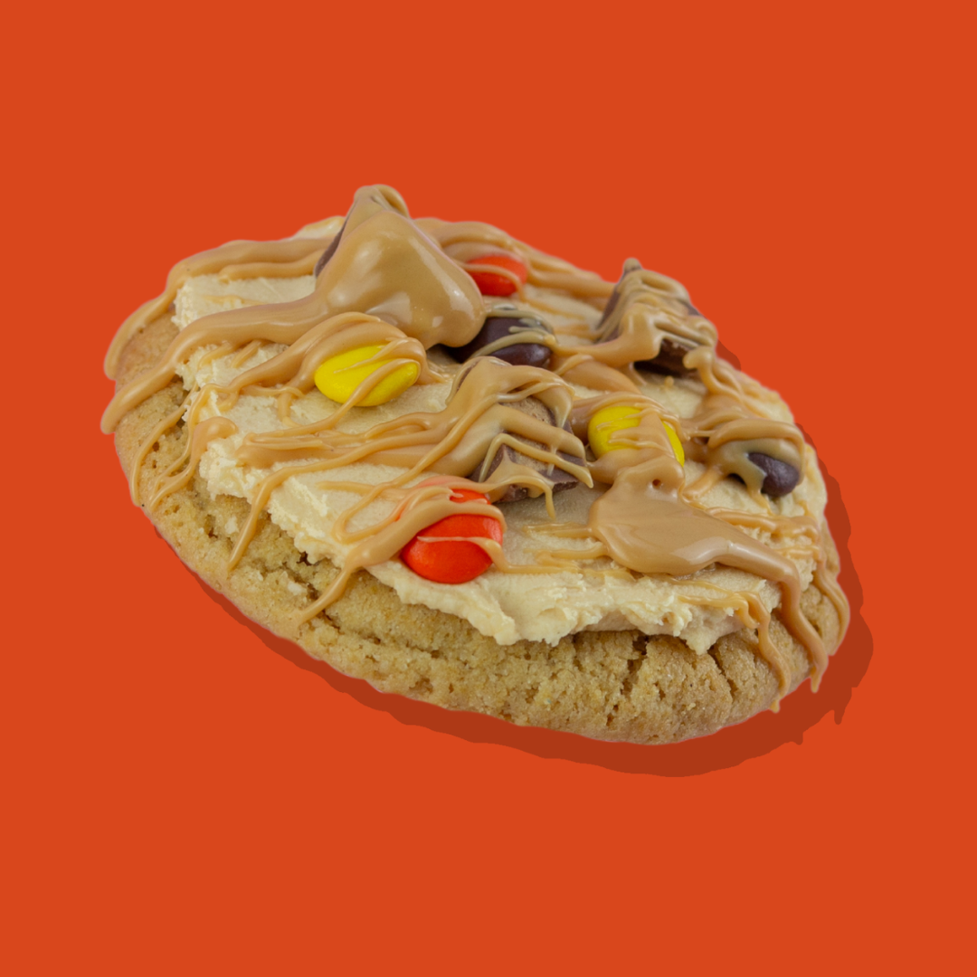 Reese's Pieces Maxi cookie with peanut butter chips, buttercream, and candy toppings.