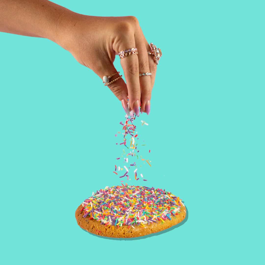 Cake batter maxi cookie with rainbow sprinkles and cream cheese frosting.