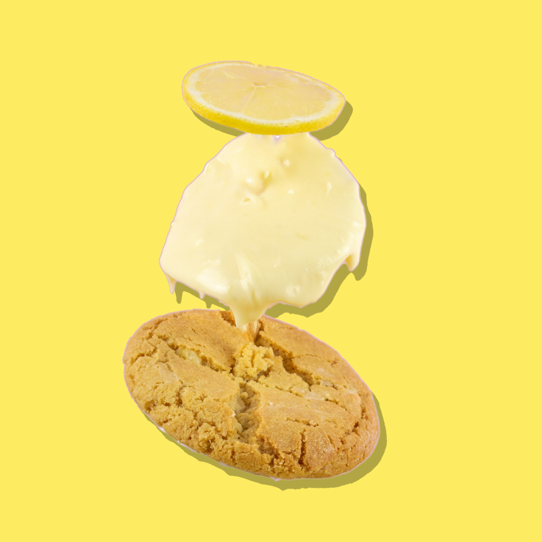 Lemon Cheesecake Cookie with white chocolate base, lemon cream cheese frosting, and lemon slice.