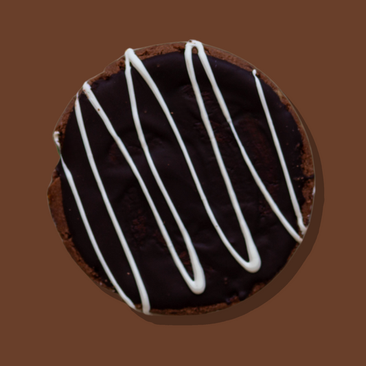 Choc Mudcake Maxi Cookie with chocolate ganache and white chocolate drizzle.