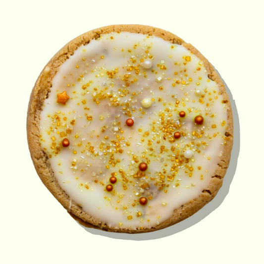 White chocolate macadamia cookie topped with gold sprinkles, Macadamia Magic Maxi.