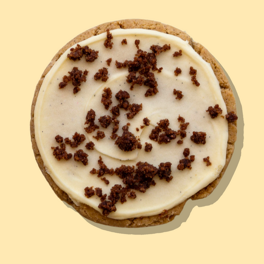 Snickerdoodle Maxi cookie with cinnamon base, vanilla cream cheese frosting, and snickerdoodle crumbs.
