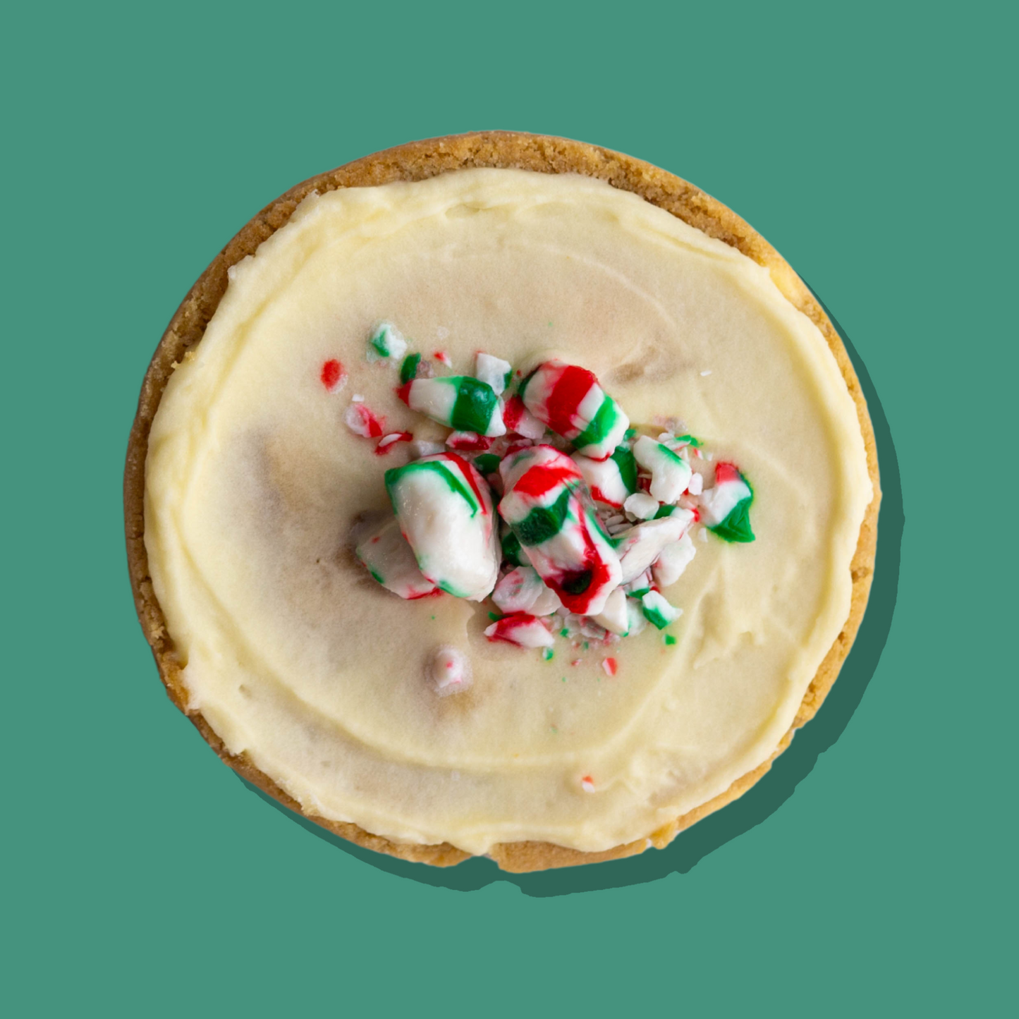 Peppermint Kiss Maxi cookie with white chocolate base, peppermint cream cheese frosting, topped with crushed peppermint candy.