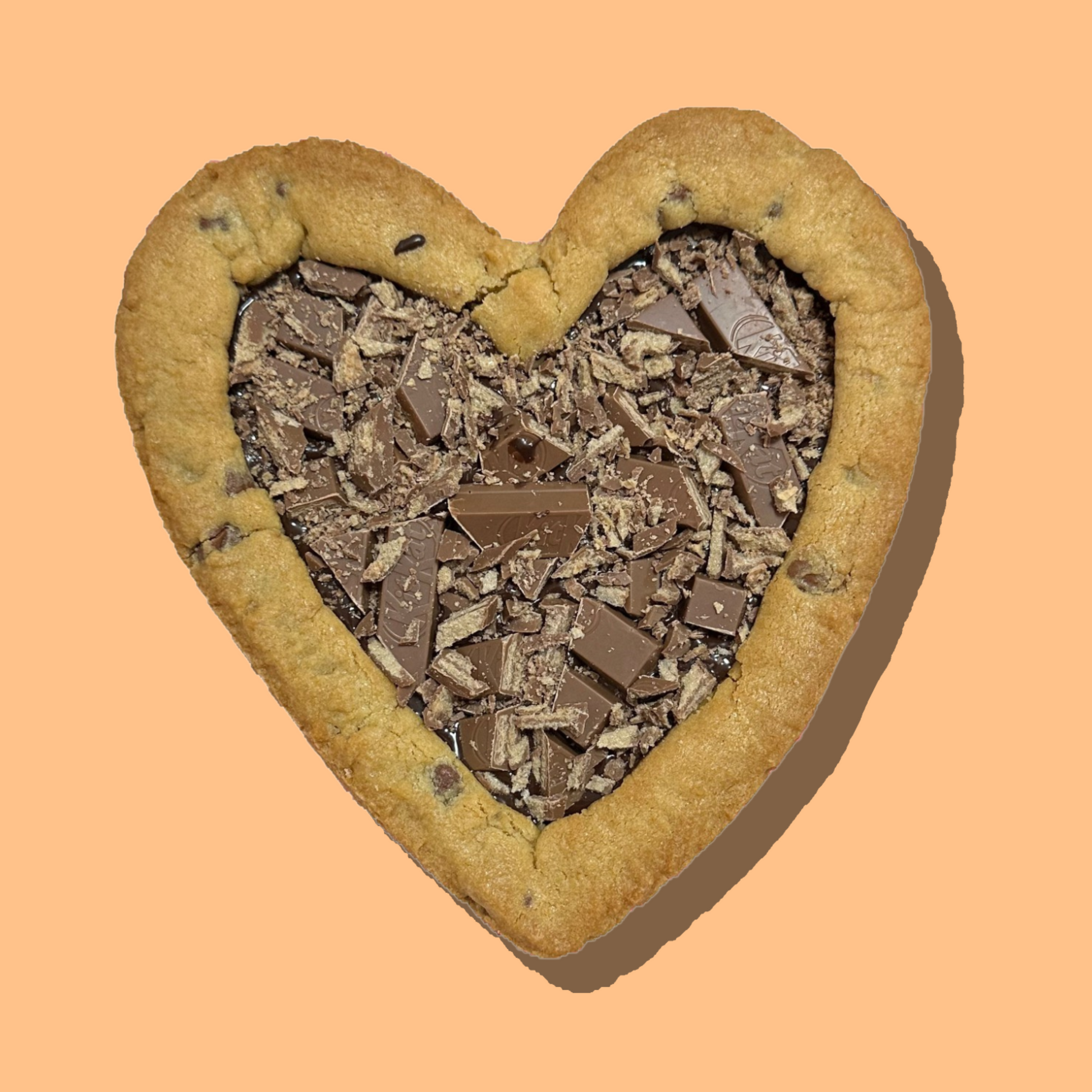 Heart-shaped customizable cookie pie with chocolate topping.