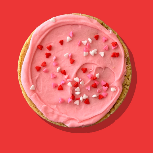 Pink Marshmallow Maxi cookie with pink marshmallow cream cheese frosting and heart sprinkles.