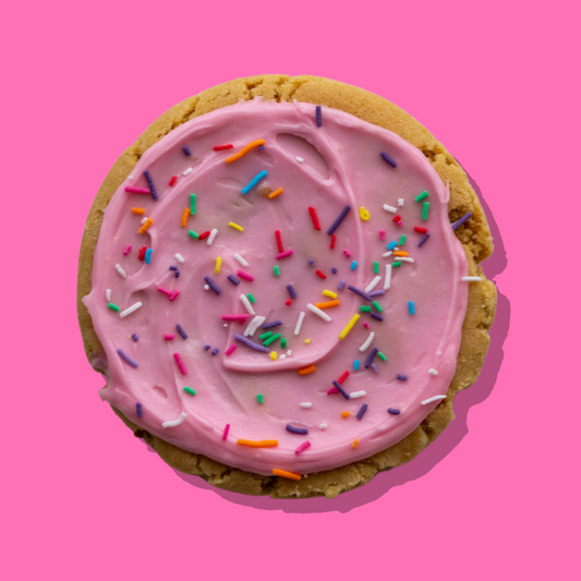 Homer Maxi cookie with white chocolate base, strawberry frosting, and rainbow sprinkles.