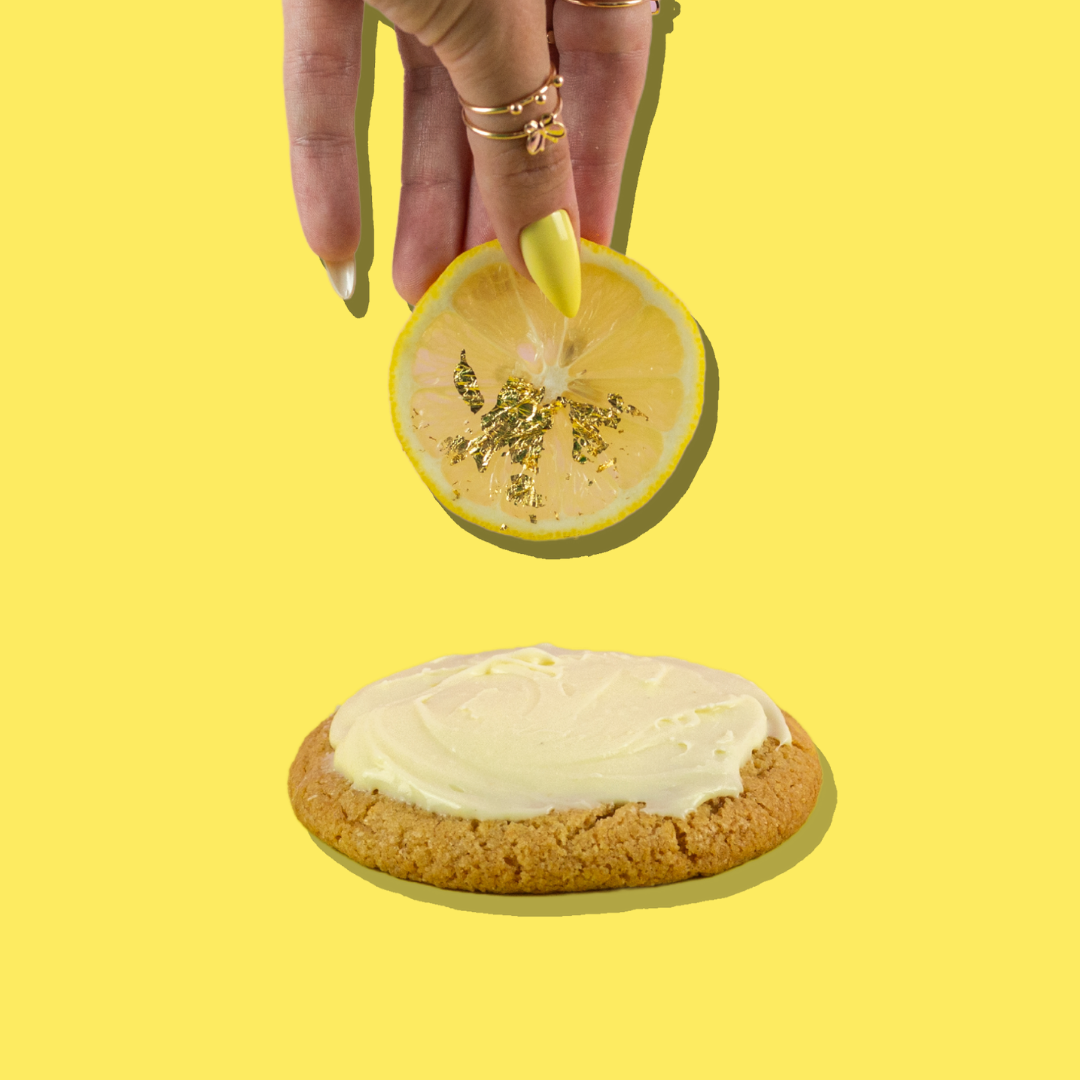 Lemon cheesecake cookie topped with cream cheese frosting and lemon slice.