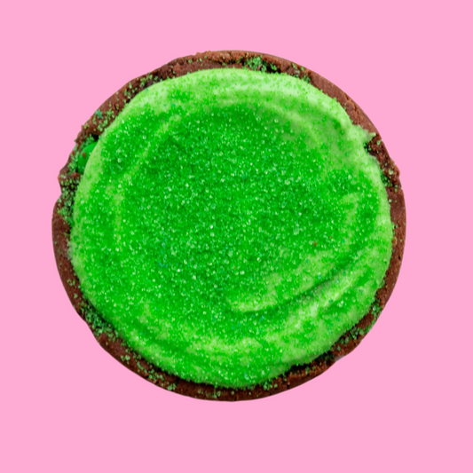 Elphaba Maxi dessert with green frosting and sugar crystals.