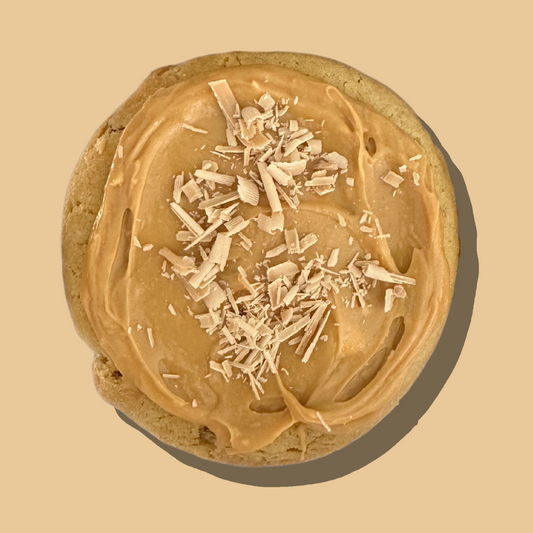 Caramel Cheesecake Cookie with cream cheese frosting and Caramilk chocolate shavings.