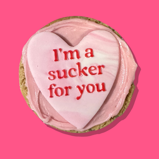 Suck My Kiss Maxi cookie with strawberry frosting and fondant heart.
